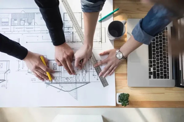high-angle-view-worker-s-hand-working-blueprint-wooden-table-workplace-scaled